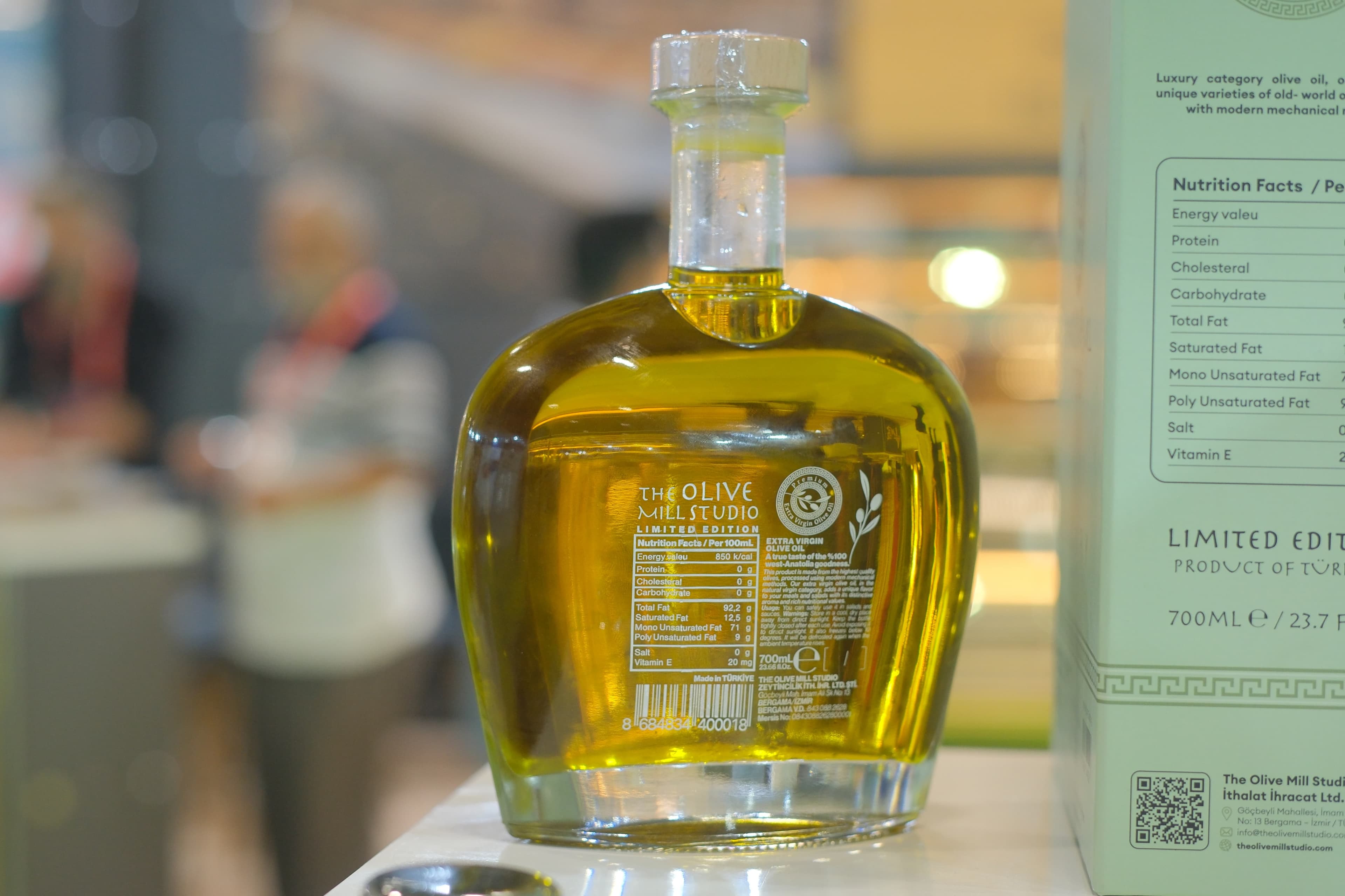 The Olive Mill Studio — estate bottle on a Mediterranean table